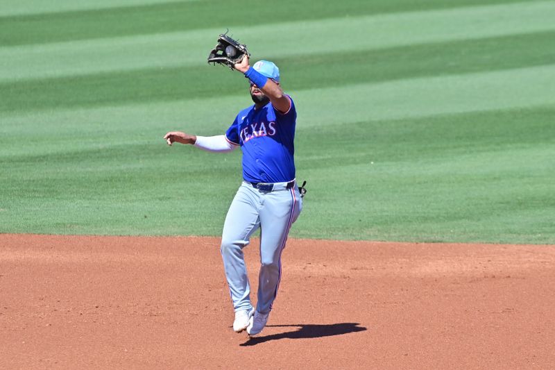 Mar 11, 2024; Tempe, Arizona, USA;  Texas Rangers shortstop Ezequiel Duran (20) fields a ball in the second inning against the Los Angeles Angels during a spring training game at Tempe Diablo Stadium. Mandatory Credit: Matt Kartozian-USA TODAY Sports