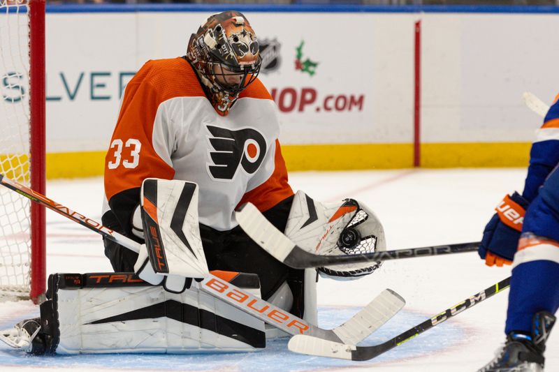 Nov 25, 2023; Elmont, New York, USA; Philadelphia Flyers goaltender Samuel Ersson (33) makes a glove save against the New York Islanders during the second period at UBS Arena. Mandatory Credit: Thomas Salus-USA TODAY Sports