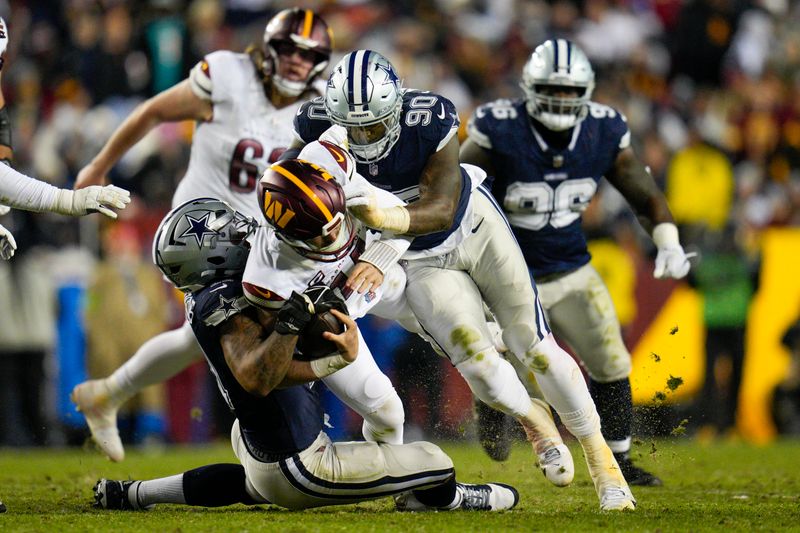 Dallas Cowboys linebacker Micah Parsons (11) and defensive end DeMarcus Lawrence (90) sack Washington Commanders quarterback Sam Howell (14) during the second half, Sunday, January 7, 2024, in Landover, Md. Dallas won 38-10. (AP Photo/Jess Rapfogel)