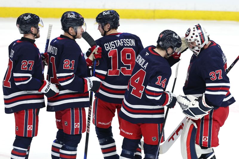 Jan 16, 2025; Winnipeg, Manitoba, CAN; Winnipeg Jets players celebrate their victory over the Seattle Kraken at Canada Life Centre. Mandatory Credit: James Carey Lauder-Imagn Images