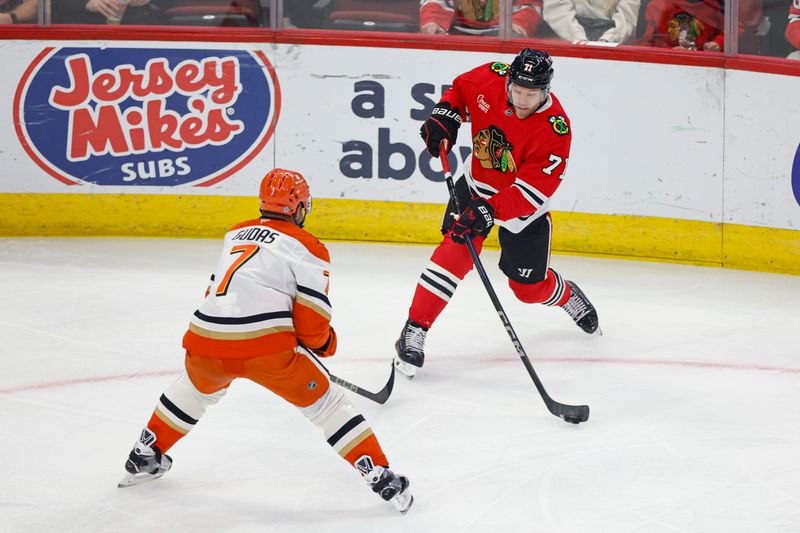 Nov 19, 2024; Chicago, Illinois, USA; Chicago Blackhawks left wing Taylor Hall (71) shoots against Anaheim Ducks defenseman Radko Gudas (7) during the first period at United Center. Mandatory Credit: Kamil Krzaczynski-Imagn Images