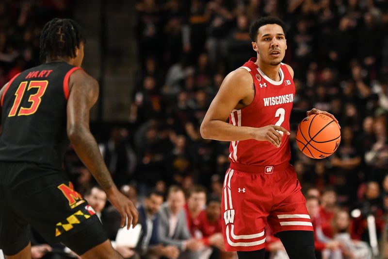 Jan 25, 2023; College Park, Maryland, USA;  Wisconsin Badgers guard Chucky Hepburn (23) dribbles as Maryland Terrapins guard Hakim Hart (13) defends during the first half at Xfinity Center. Mandatory Credit: Tommy Gilligan-USA TODAY Sports