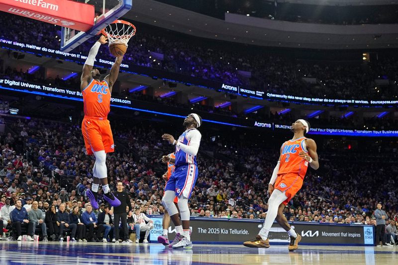 PHILADELPHIA, PENNSYLVANIA - JANUARY 14: Luguentz Dort #5 of the Oklahoma City Thunder dunks the ball against Reggie Jackson #00 of the Philadelphia 76ers in the first half at the Wells Fargo Center on January 14, 2025 in Philadelphia, Pennsylvania. NOTE TO USER: User expressly acknowledges and agrees that, by downloading and/or using this photograph, user is consenting to the terms and conditions of the Getty Images License Agreement. (Photo by Mitchell Leff/Getty Images)