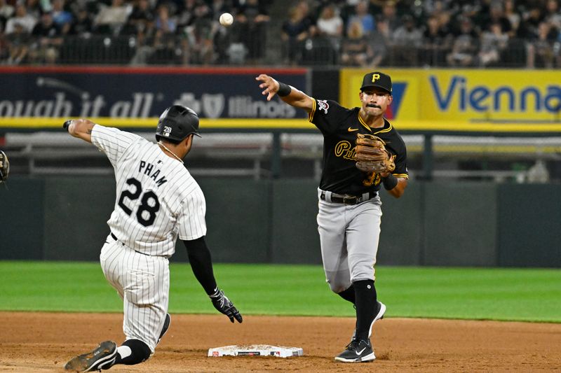 Jul 12, 2024; Chicago, Illinois, USA;  Pittsburgh Pirates second baseman Nick Gonzales (39) complete a double play after forcing out Chicago White Sox outfielder Tommy Pham (28) during the eighth inning at Guaranteed Rate Field. Mandatory Credit: Matt Marton-USA TODAY Sports