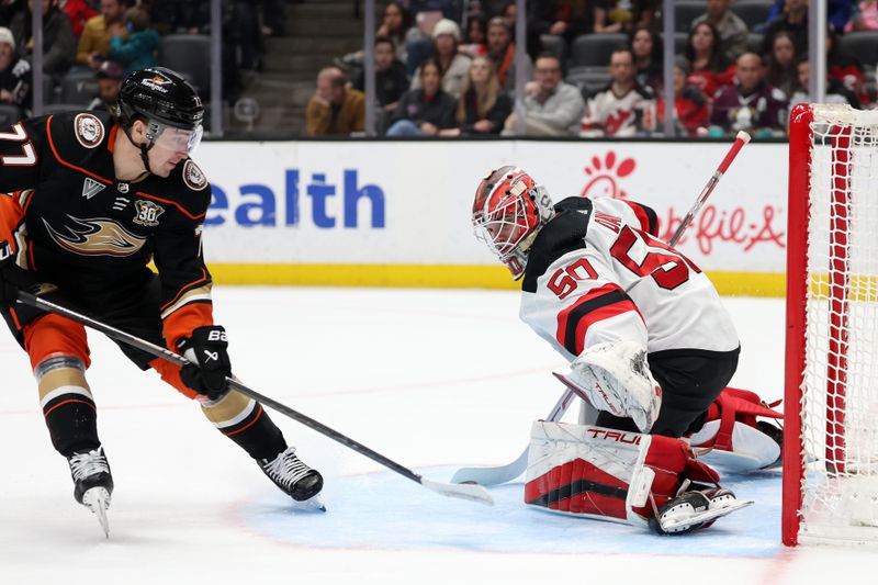 Mar 1, 2024; Anaheim, California, USA; Anaheim Ducks right wing Frank Vatrano (77) scores a goal against New Jersey Devils goaltender Nico Daws (50) during the second period at Honda Center. Mandatory Credit: Kiyoshi Mio-USA TODAY Sports