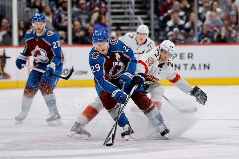 Jan 6, 2024; Denver, Colorado, USA; Colorado Avalanche center Nathan MacKinnon (29) and Florida Panthers center Eetu Luostarinen (27) battle for the puck in the first period at Ball Arena. Mandatory Credit: Isaiah J. Downing-USA TODAY Sports