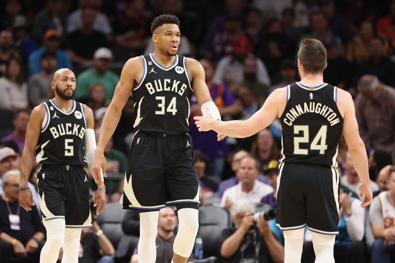 PHOENIX, ARIZONA - MARCH 14: Giannis Antetokounmpo #34 of the Milwaukee Bucks high fives Pat Connaughton #24 after scoring against the Phoenix Suns during the first half of the NBA game at Footprint Center on March 14, 2023 in Phoenix, Arizona.   NOTE TO USER: User expressly acknowledges and agrees that, by downloading and or using this photograph, User is consenting to the terms and conditions of the Getty Images License Agreement.  (Photo by Christian Petersen/Getty Images)