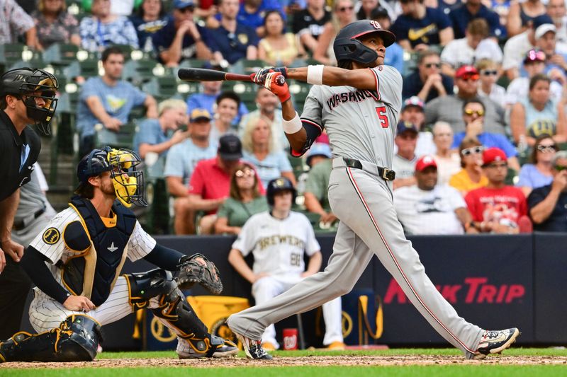 Jul 13, 2024; Milwaukee, Wisconsin, USA; Washington Nationals shortstop C.J. Abrams (5) hits a 2-run home run against the Milwaukee Brewers in the ninth inning at American Family Field. Mandatory Credit: Benny Sieu-USA TODAY Sports