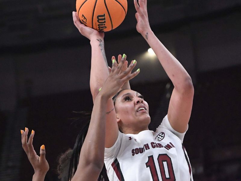 Mar 3, 2023; Greenville, SC, USA; South Carolina center Kamilla Cardoso (10) scores near Arkansas forward Maryam Dauda (30) during the fourth quarter at Bon Secours Wellness Arena. Mandatory Credit: Ken Ruinard-USA TODAY Sports