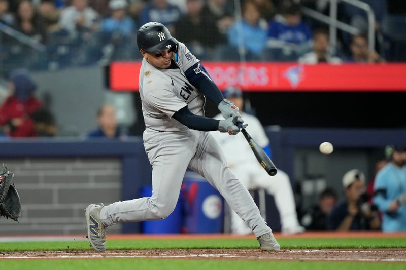 Apr 16, 2024; Toronto, Ontario, CAN; New York Yankees catcher Jose Trevino (39) hits a one run single against the Toronto Blue Jays during the second inning at Rogers Centre. Mandatory Credit: John E. Sokolowski-USA TODAY Sports