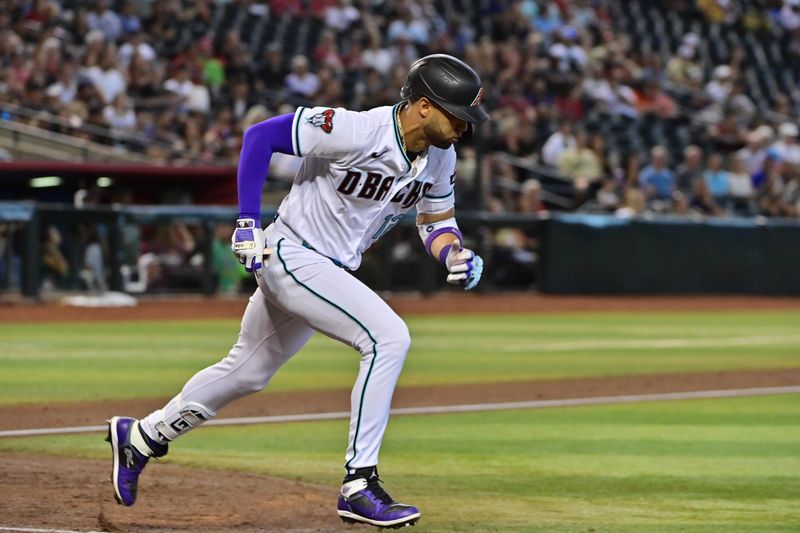 Sep 20, 2023; Phoenix, Arizona, USA;  Arizona Diamondbacks left fielder Lourdes Gurriel Jr. (12) runs after hitting a single in the second inning against the San Francisco Giants at Chase Field. Mandatory Credit: Matt Kartozian-USA TODAY Sports