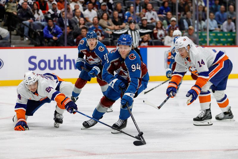 Oct 14, 2024; Denver, Colorado, USA; New York Islanders defenseman Scott Mayfield (24) knocks the puck away from Colorado Avalanche left wing Joel Kiviranta (94) as center Bo Horvat (14) and center Parker Kelly (17) defend in the second period at Ball Arena. Mandatory Credit: Isaiah J. Downing-Imagn Images