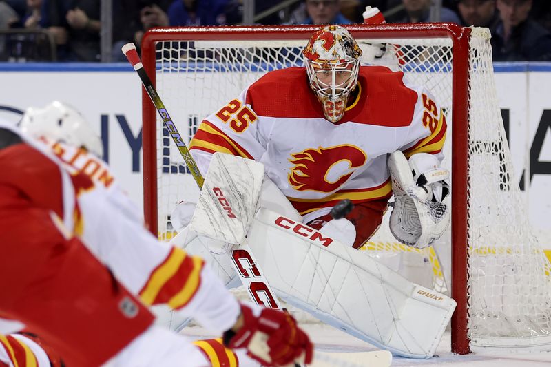 Feb 12, 2024; New York, New York, USA; Calgary Flames goaltender Jacob Markstrom (25) makes a save against the New York Rangers during the first period at Madison Square Garden. Mandatory Credit: Brad Penner-USA TODAY Sports