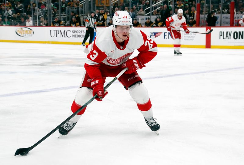 Mar 17, 2024; Pittsburgh, Pennsylvania, USA;  Detroit Red Wings left wing Lucas Raymond (23) skates with the puck against the Pittsburgh Penguins during the second period at PPG Paints Arena. Mandatory Credit: Charles LeClaire-USA TODAY Sports