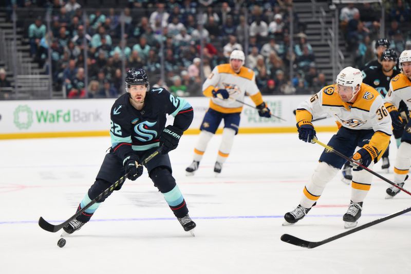 Nov 2, 2023; Seattle, Washington, USA; Seattle Kraken right wing Oliver Bjorkstrand (22) plays the puck against the Nashville Predators during the third period at Climate Pledge Arena. Mandatory Credit: Steven Bisig-USA TODAY Sports