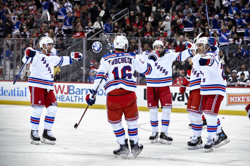 Nov 18, 2023; Newark, New Jersey, USA; New York Rangers left wing Artemi Panarin (10) celebrates with teammates after scoring a goal against the New Jersey Devils during the first period at Prudential Center. Mandatory Credit: John Jones-USA TODAY Sports