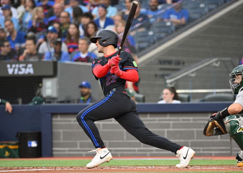 May 30, 2025; Toronto, Ontario, CAN;  Toronto Blue Jays second baseman Ernie Clement (22) hits a double against the Athletics in the second inning at Rogers Centre. Mandatory Credit: Dan Hamilton-Imagn Images