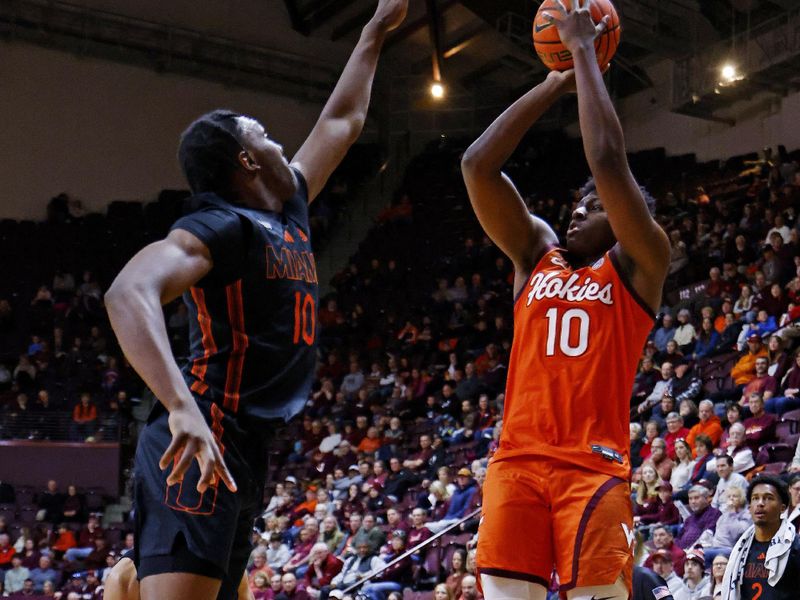 Jan 4, 2025; Blacksburg, Virginia, USA; Virginia Tech Hokies guard Tyler Johnson (10) shoots the ball against Miami Hurricanes guard Paul Djobet (10) during the first half at Cassell Coliseum. Mandatory Credit: Peter Casey-Imagn Images