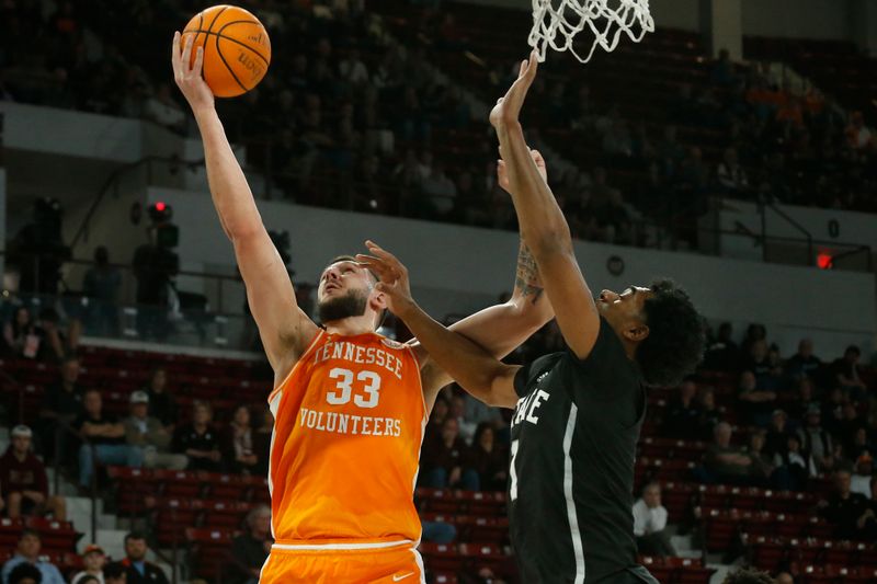 Jan 17, 2023; Starkville, Mississippi, USA; Tennessee Volunteers forward Uros Plavsic (33) shoots as Mississippi State Bulldogs forward Tolu Smith (1) defends during the first half at Humphrey Coliseum. Mandatory Credit: Petre Thomas-USA TODAY Sports