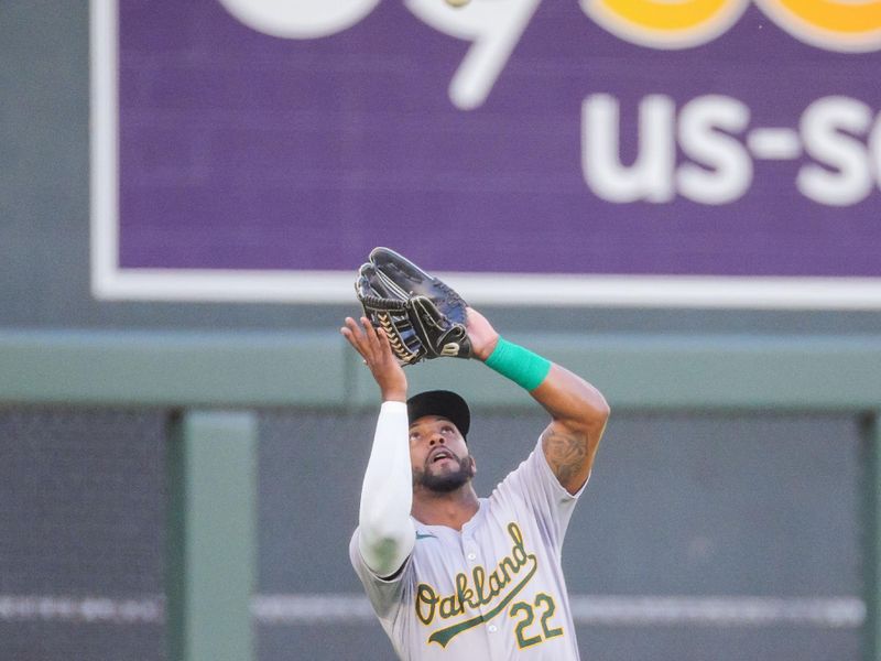 Jun 13, 2024; Minneapolis, Minnesota, USA; Oakland Athletics outfielder Miguel Andujar (22) fields a fly ball against the Minnesota Twins in the second inning at Target Field. Mandatory Credit: Brad Rempel-USA TODAY Sports