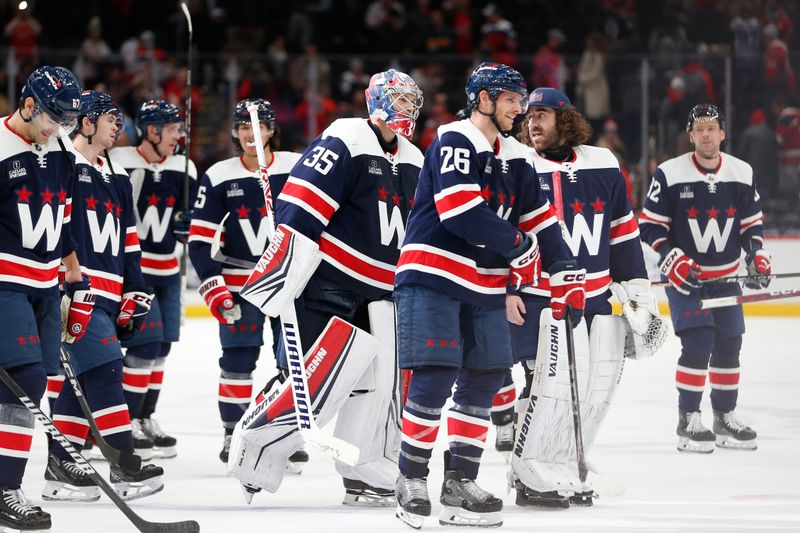 Jan 7, 2024; Washington, District of Columbia, USA; Washington Capitals goaltender Darcy Kuemper (35) skates off the ice with teammates after defeating the Los Angeles Kings at Capital One Arena. Mandatory Credit: Amber Searls-USA TODAY Sports