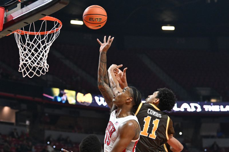 Feb 3, 2024; Las Vegas, Nevada, USA; UNLV Rebels guard Luis Rodriguez (15) scores on Wyoming Cowboys guard Kael Combs (11) in the first half at Thomas & Mack Center. Mandatory Credit: Candice Ward-USA TODAY Sports