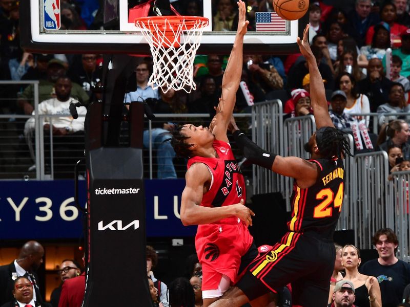 ATLANTA, GA - February 23:  Bruno Fernando #24 of the Atlanta Hawks drives to the basket during the game as Scottie Barnes #4 of the Toronto Raptors plays defense on February 23, 2024 at State Farm Arena in Atlanta, Georgia.  NOTE TO USER: User expressly acknowledges and agrees that, by downloading and/or using this Photograph, user is consenting to the terms and conditions of the Getty Images License Agreement. Mandatory Copyright Notice: Copyright 2024 NBAE (Photo by Scott Cunningham/NBAE via Getty Images)