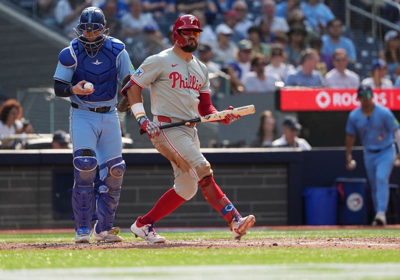 Sep 4, 2024; Toronto, Ontario, CAN; Philadelphia Phillies left fielder Kyle Schwarber (12) reacts after striking out against the Toronto Blue Jays during the fifth inning at Rogers Centre. Mandatory Credit: Nick Turchiaro-Imagn Images