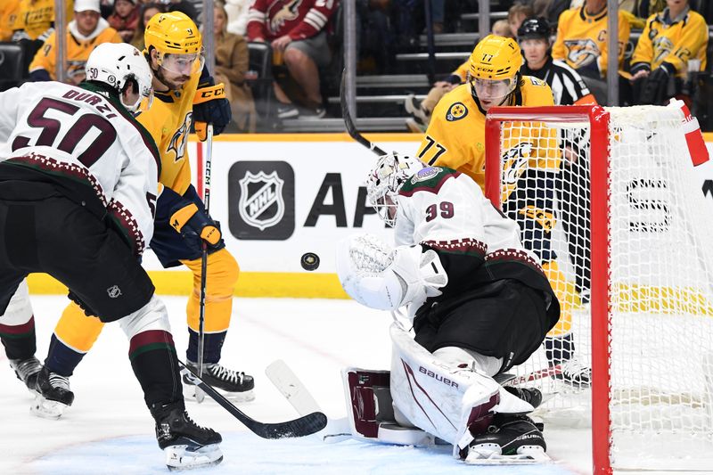 Nov 11, 2023; Nashville, Tennessee, USA; Arizona Coyotes goaltender Connor Ingram (39) blocks a shot attempt by Nashville Predators right wing Luke Evangelista (77) during the first period at Bridgestone Arena. Mandatory Credit: Christopher Hanewinckel-USA TODAY Sports