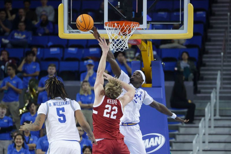 Jan 3, 2024; Los Angeles, California, USA; UCLA forward Adam Bona (3) blocks a shot by Stanford Cardinal forward James Keefe (22) during the second half at Pauley Pavilion presented by Wescom. Mandatory Credit: Yannick Peterhans-USA TODAY Sports