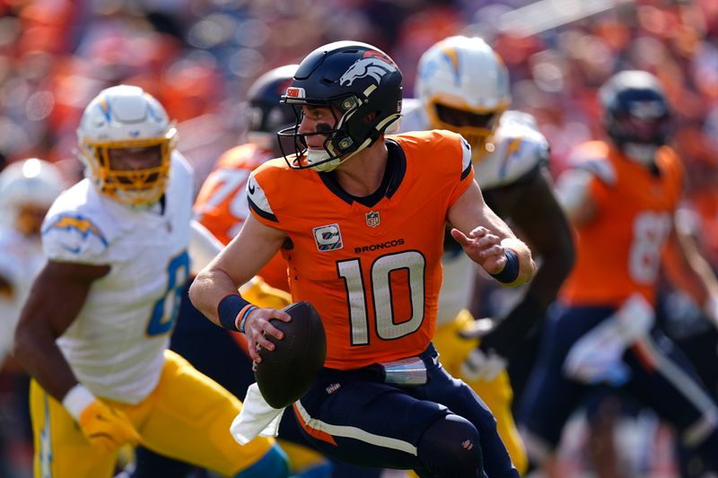 Denver Broncos quarterback Bo Nix (10) scrambles during the first half of an NFL football game against the Los Angeles Chargers, Sunday, Oct. 13, 2024, in Denver. (AP Photo/David Zalubowski)