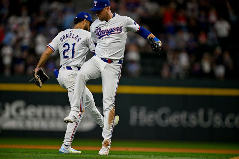 Jul 6, 2024; Arlington, Texas, USA; Texas Rangers third baseman Jonathan Ornelas (21) and first baseman Nathaniel Lowe (30) celebrate after the Rangers defeat the Tampa Bay Rays at Globe Life Field. Mandatory Credit: Jerome Miron-USA TODAY Sports