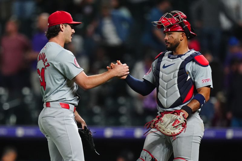 Sep 24, 2024; Denver, Colorado, USA; St. Louis Cardinals relief pitcher Ryan Fernandez (64) and catcher Ivan Herrera (48) celebrate defeating the Colorado Rockies at Coors Field. Mandatory Credit: Ron Chenoy-Imagn Images