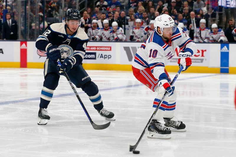 Oct 14, 2023; Columbus, Ohio, USA; New York Rangers left wing Artemi Panarin (10) carries the puck as Columbus Blue Jackets center Alexander Texier (42) trails the play during the second period at Nationwide Arena. Mandatory Credit: Russell LaBounty-USA TODAY Sports