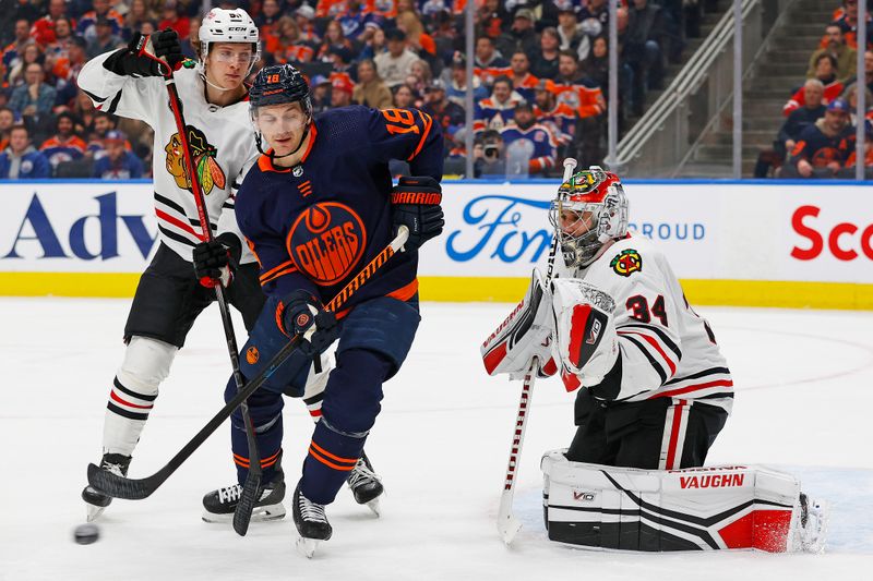 Jan 25, 2024; Edmonton, Alberta, CAN; Edmonton Oilers forward Zach Hyman (18) tries to deflect a shot on Chicago Blackhawks goaltender Petr Mrazek (34) during the first period at Rogers Place. Mandatory Credit: Perry Nelson-USA TODAY Sports