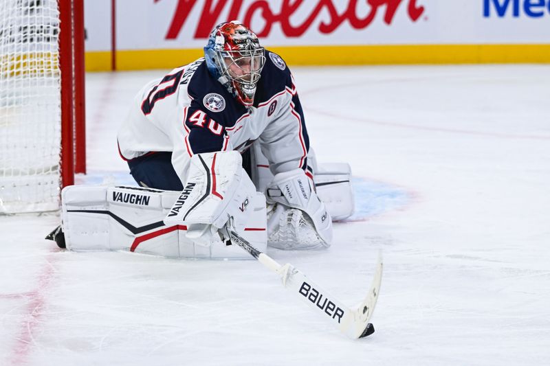 Nov 16, 2024; Montreal, Quebec, CAN; Columbus Blue Jackets goalie Daniil Tarasov (40) reaches out with his stick to intercept the puck against the Montreal Canadiens during the second period at Bell Centre. Mandatory Credit: David Kirouac-Imagn Images