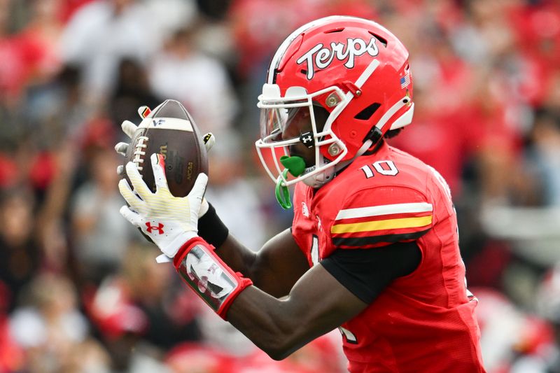 Sep 30, 2023; College Park, Maryland, USA; Maryland Terrapins wide receiver Tai Felton (10) has   picture of Scott Van Pelt is displayed on  his arm band as he catches a pass for a touchdown during the first half  against the Indiana Hoosiers at SECU Stadium. Mandatory Credit: Tommy Gilligan-USA TODAY Sports