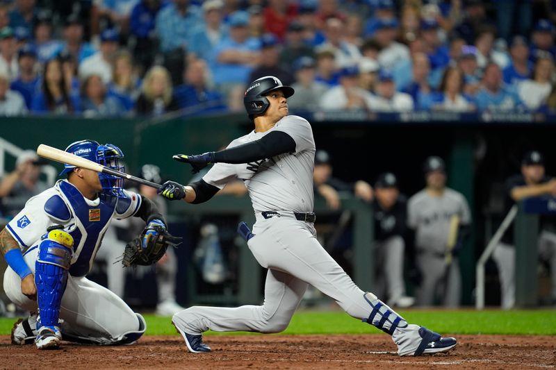 Oct 9, 2024; Kansas City, Missouri, USA; New York Yankees shortstop Anthony Volpe (11) hits a sacrifice fly ball in the fifth inning against the Kansas City Royals during game three of the NLDS for the 2024 MLB Playoffs at Kauffman Stadium. Mandatory Credit: Jay Biggerstaff -Imagn Images