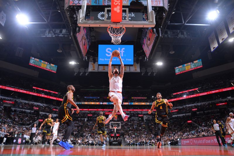 SAN ANTONIO, TX - MARCH 31: Sandro Mamukelashvili #54 of the San Antonio Spurs  dunks the ball during the game against the Golden State Warriors on March 31, 2024 at the Frost Bank Center in San Antonio, Texas. NOTE TO USER: User expressly acknowledges and agrees that, by downloading and or using this photograph, user is consenting to the terms and conditions of the Getty Images License Agreement. Mandatory Copyright Notice: Copyright 2024 NBAE (Photos by Michael Gonzales/NBAE via Getty Images)