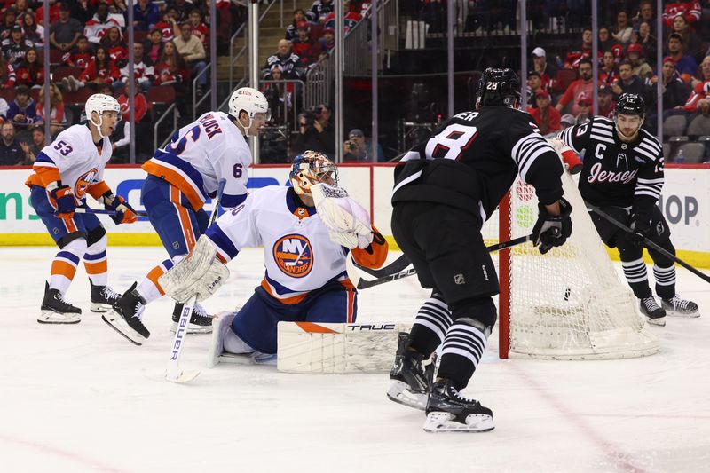 Apr 15, 2024; Newark, New Jersey, USA; New Jersey Devils right wing Timo Meier (28) scores a goal on New York Islanders goaltender Semyon Varlamov (40) during the second period at Prudential Center. Mandatory Credit: Ed Mulholland-USA TODAY Sports