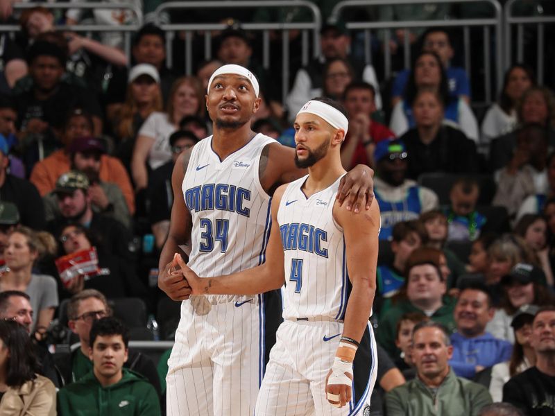 MILWAUKEE, WI - APRIL 10: Jalen Suggs #4 and Wendell Carter Jr. #34 of the Orlando Magic embrace during the game against the Milwaukee Bucks on April 10, 2024 at the Fiserv Forum Center in Milwaukee, Wisconsin. NOTE TO USER: User expressly acknowledges and agrees that, by downloading and or using this Photograph, user is consenting to the terms and conditions of the Getty Images License Agreement. Mandatory Copyright Notice: Copyright 2024 NBAE (Photo by Gary Dineen/NBAE via Getty Images).