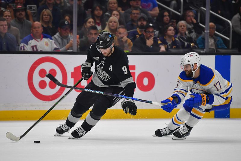 Mar 21, 2026; Los Angeles, California, USA; Los Angeles Kings right wing Adrian Kempe (9) moves the puck against Buffalo Sabres left wing Jason Zucker (17) during the first period at Crypto.com Arena. Mandatory Credit: Gary A. Vasquez-Imagn Images
