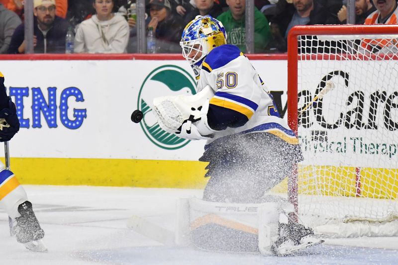 Mar 4, 2024; Philadelphia, Pennsylvania, USA; St. Louis Blues goaltender Jordan Binnington (50) makes a save against the Philadelphia Flyers during the second period at Wells Fargo Center. Mandatory Credit: Eric Hartline-USA TODAY Sports