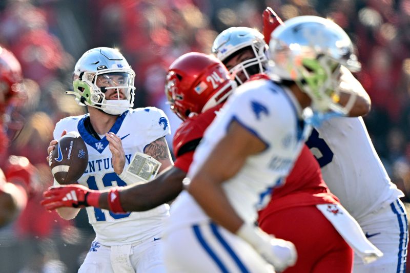 Nov 25, 2023; Louisville, Kentucky, USA;  Kentucky Wildcats quarterback Devin Leary (13) looks to pass against the Louisville Cardinals during the second half at L&N Federal Credit Union Stadium. Kentucky defeated Louisville 38-31. Mandatory Credit: Jamie Rhodes-USA TODAY Sports