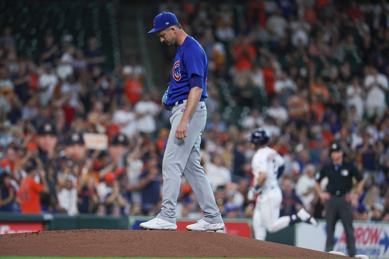 May 17, 2023; Houston, Texas, USA; Chicago Cubs starting pitcher Drew Smyly (11) reacts and Houston Astros third baseman Alex Bregman (2) rounds the bases after hitting a home run during the first inning at Minute Maid Park. Mandatory Credit: Troy Taormina-USA TODAY Sports