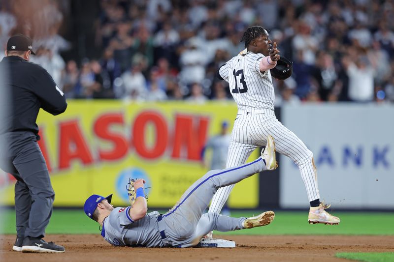 Oct 5, 2024; Bronx, New York, USA; New York Yankees third base Jazz Chisholm Jr. (13) steals second base against Kansas City Royals second base Michael Massey (19) during the seventh inning during game one of the ALDS for the 2024 MLB Playoffs at Yankee Stadium. Mandatory Credit: Brad Penner-Imagn Images