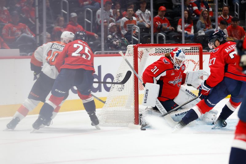 Sep 22, 2024; Washington, District of Columbia, USA; Washington Capitals goaltender Hunter Shepard (31) makes a save on Philadelphia Flyers forward Bobby Brink (10) Capitals defenseman Ethan Bear (25) defends in the second period at Capital One Arena. Mandatory Credit: Geoff Burke-Imagn Images