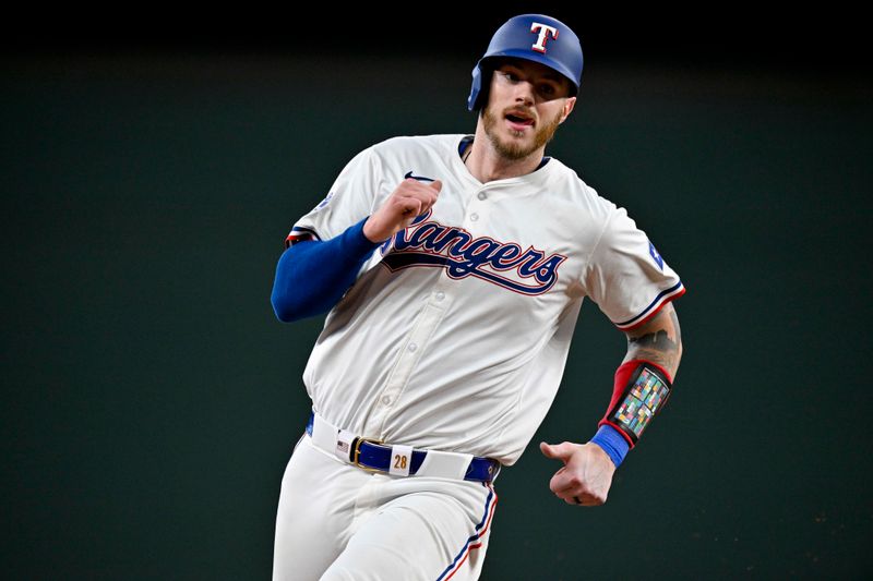 May 2, 2024; Arlington, Texas, USA; Texas Rangers catcher Jonah Heim (28) runs to third base during the eighth inning against the Washington Nationals at Globe Life Field. Mandatory Credit: Jerome Miron-USA TODAY Sports