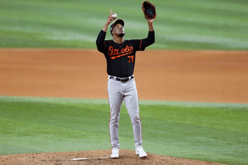 Oct 10, 2023; Arlington, Texas, USA; Baltimore Orioles relief pitcher Yennier Cano (78) reacts after walking onto the mound in the eighth inning against the Texas Rangers during game three of the ALDS for the 2023 MLB playoffs at Globe Life Field. Mandatory Credit: Andrew Dieb-USA TODAY Sports