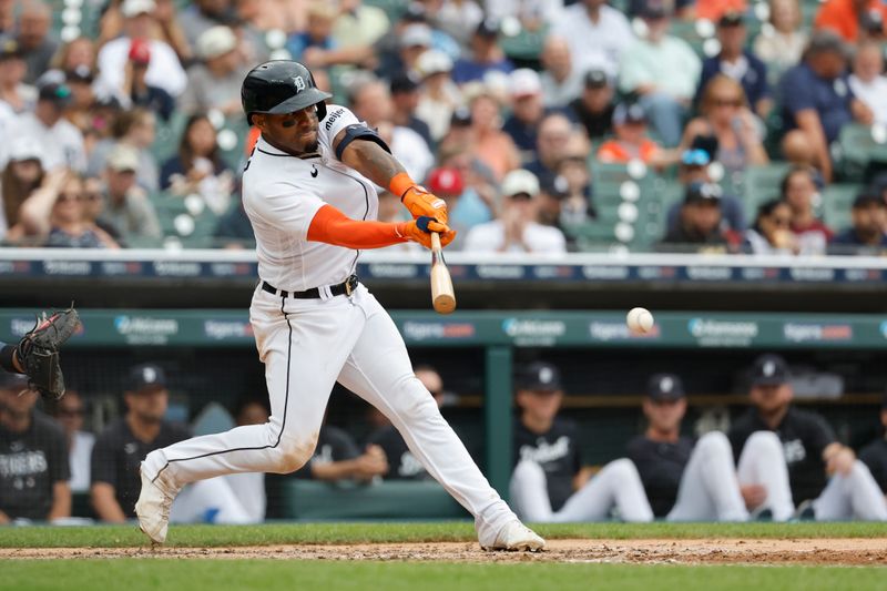 Aug 6, 2023; Detroit, Michigan, USA; Detroit Tigers second baseman Andy Ibanez (77) hits an RBI single in the fourth inning against the Tampa Bay Rays at Comerica Park. Mandatory Credit: Rick Osentoski-USA TODAY Sports